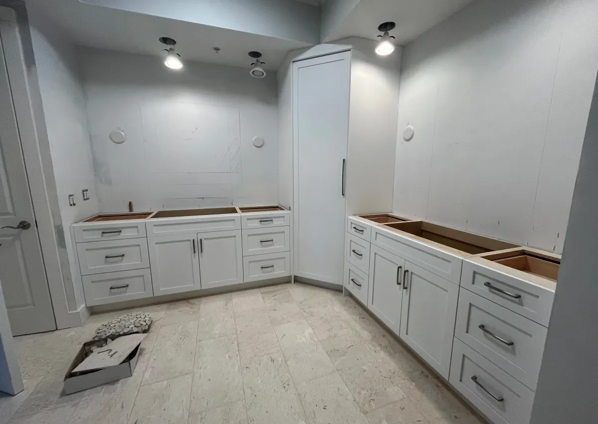 Luxurious custom walk-in closet with premium cabinetry by EG Contractors in Naples, FL