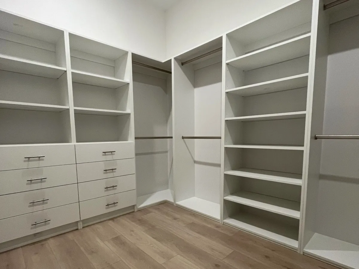 Walk-in closet with custom shelving and drawers