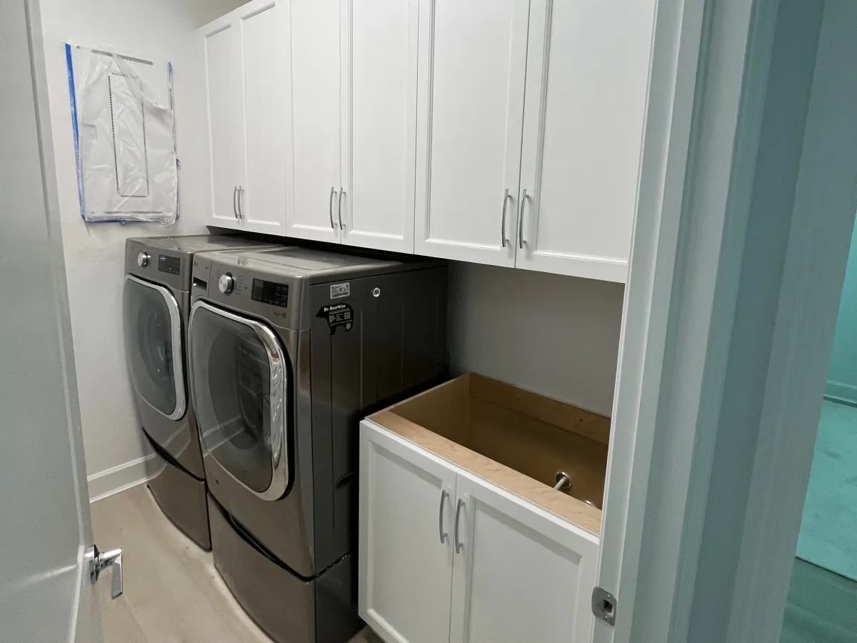 Laundry room with upper cabinets and folding counter
